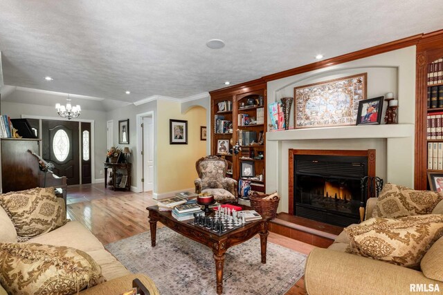 1300 W Brewster Rd, Herrin, IL 62948 - living area featuring recessed lighting, a chandelier, wood finished floors, a lit fireplace, and crown molding