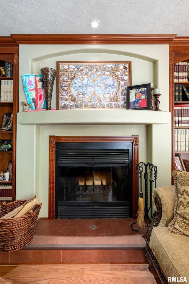 1300 W Brewster Rd, Herrin, IL 62948 - detailed view of a glass covered fireplace, ornamental molding, a textured ceiling, and wood finished floors