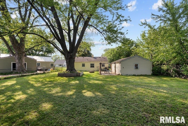 1623 Alcoa Ave, Bettendorf, IA 52722 - view of grassy yard with an outbuilding