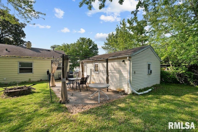 1623 Alcoa Ave, Bettendorf, IA 52722 - view of grassy yard featuring an outdoor fire pit and a patio area
