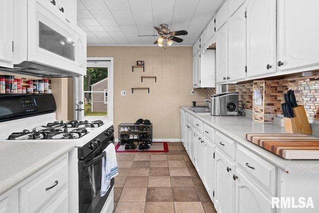1623 Alcoa Ave, Bettendorf, IA 52722 - kitchen with gas range oven, white microwave, a ceiling fan, white cabinetry, and light countertops