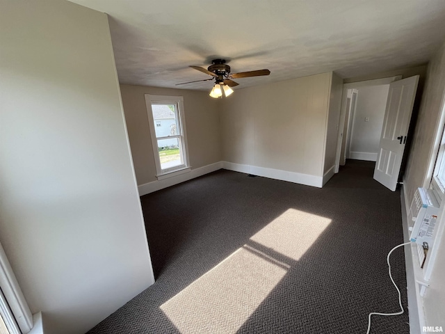 212 S E St, Cambridge, IL 61238 - spare room featuring ceiling fan and dark carpet