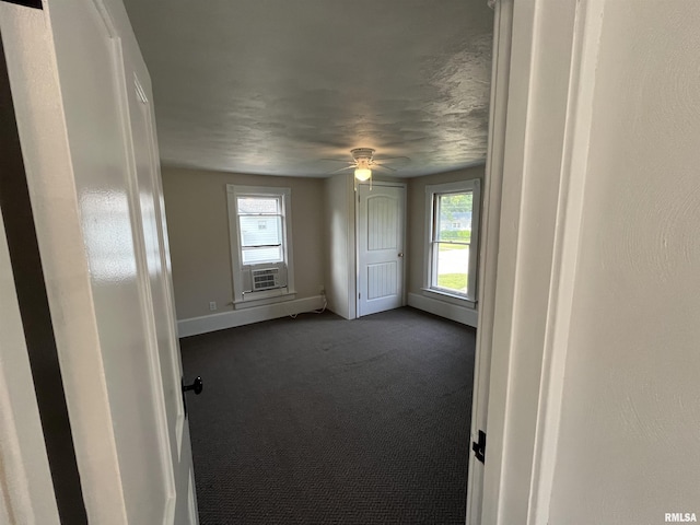 212 S E St, Cambridge, IL 61238 - unfurnished room with dark carpet, a ceiling fan, and cooling unit