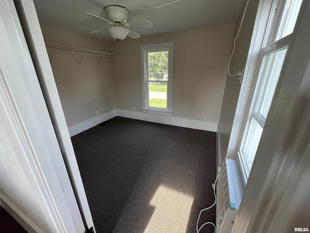 212 S E St, Cambridge, IL 61238 - spare room with dark carpet and a ceiling fan