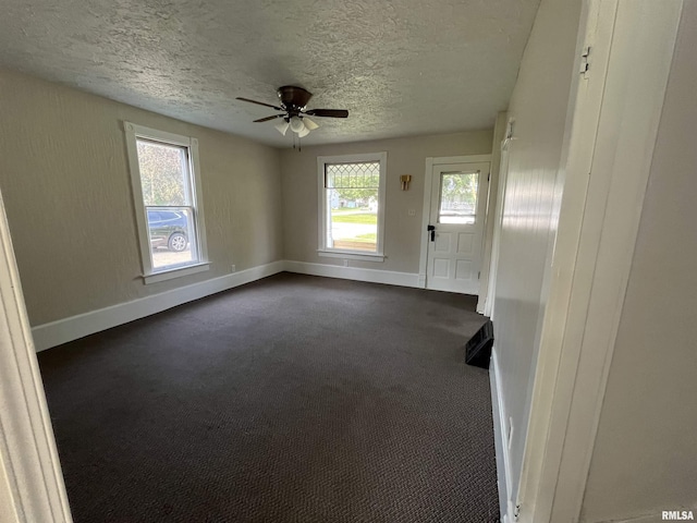 212 S E St, Cambridge, IL 61238 - unfurnished room with a textured ceiling, ceiling fan, and dark carpet