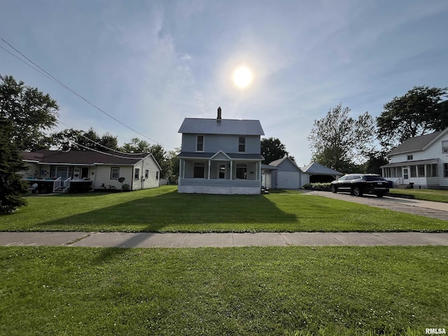 212 S E St, Cambridge, IL 61238 - view of front of home featuring a front yard, a metal roof, a garage, and driveway