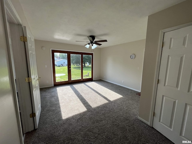 212 S E St, Cambridge, IL 61238 - unfurnished room with a ceiling fan and dark colored carpet