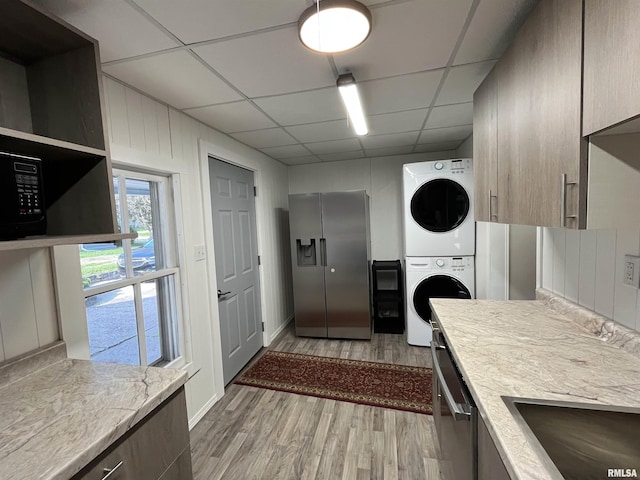 212 S E St, Cambridge, IL 61238 - washroom with stacked washing machine and dryer and light wood finished floors