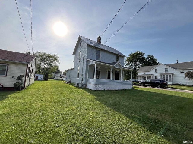 212 S E St, Cambridge, IL 61238 - rear view of property with a lawn and a metal roof