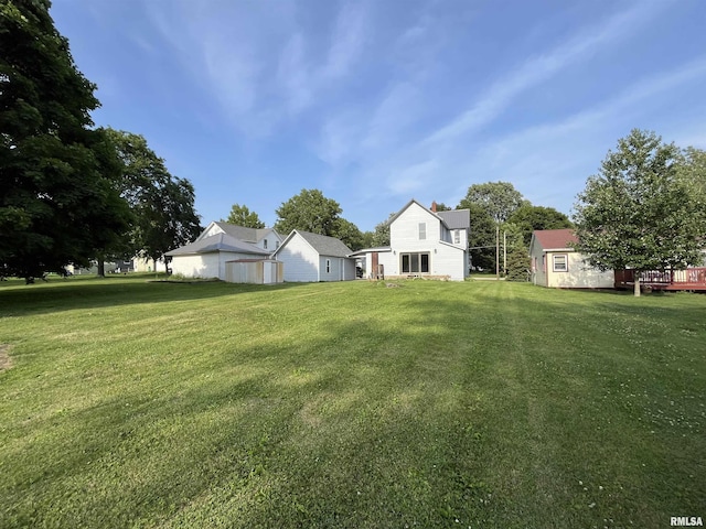 212 S E St, Cambridge, IL 61238 - view of grassy yard featuring a deck and a shed