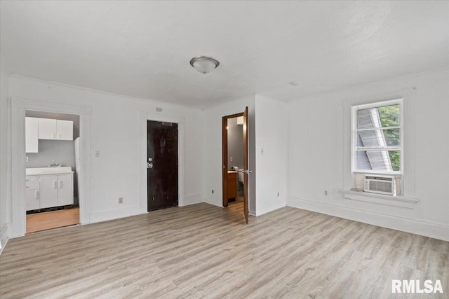 1309 Perry St, Davenport, IA 52803 - unfurnished bedroom with light wood-style floors, ensuite bathroom, and cooling unit