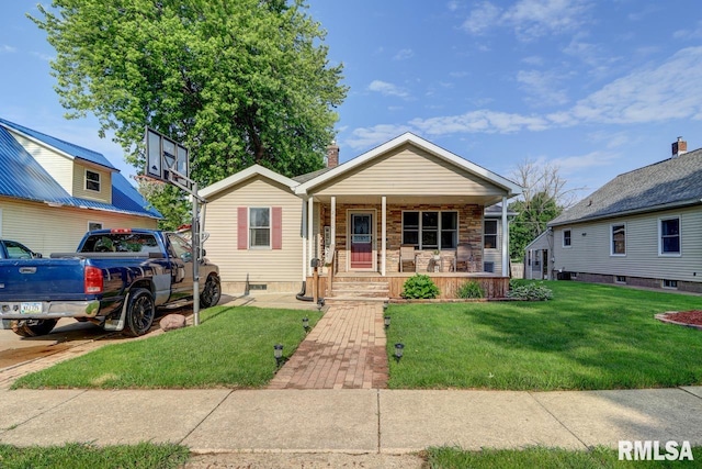 2410 Barker St, Clinton, IA 52732 - view of front facade with covered porch, a front yard, and a chimney