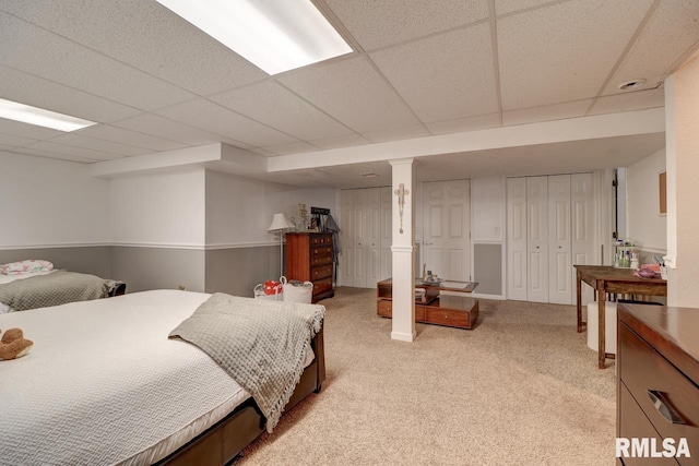 2410 Barker St, Clinton, IA 52732 - bedroom featuring light carpet, two closets, and a drop ceiling