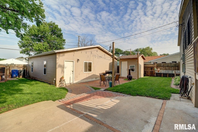 2410 Barker St, Clinton, IA 52732 - rear view of property featuring an outbuilding and a patio