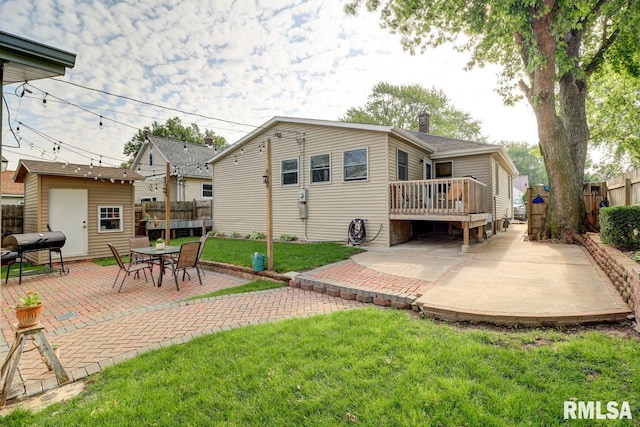2410 Barker St, Clinton, IA 52732 - back of property featuring a patio area, a wooden deck, a fenced backyard, and a shed