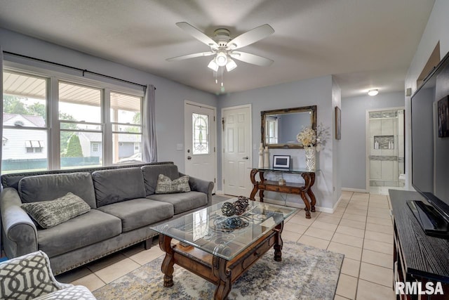 2410 Barker St, Clinton, IA 52732 - living room with light tile patterned floors and a ceiling fan