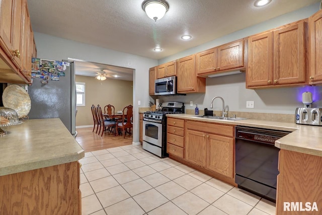 2410 Barker St, Clinton, IA 52732 - kitchen featuring stainless steel appliances, light countertops, a ceiling fan, light tile patterned flooring, and recessed lighting