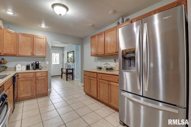 2410 Barker St, Clinton, IA 52732 - kitchen with stainless steel fridge with ice dispenser, light countertops, light tile patterned floors, a textured ceiling, and recessed lighting