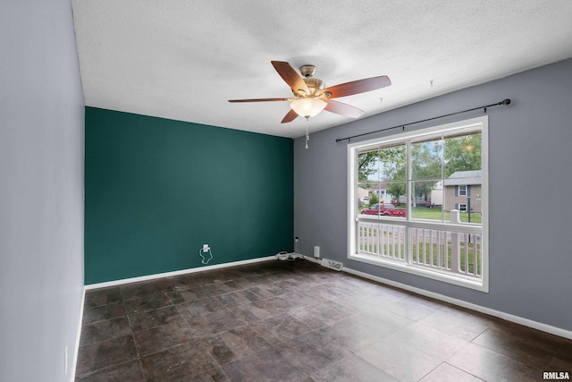 409 W 30th Ave, Milan, IL 61264 - spare room with ceiling fan and a textured ceiling