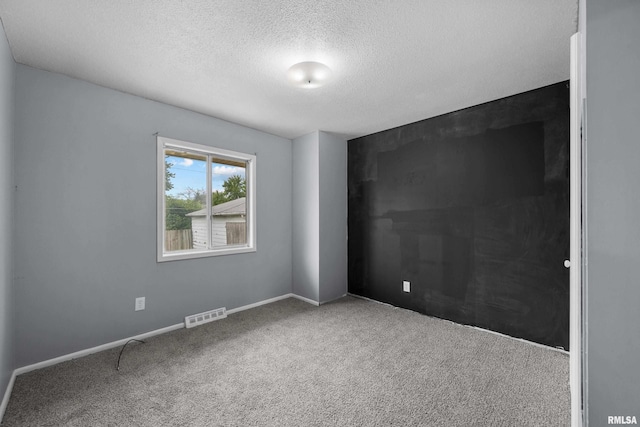 409 W 30th Ave, Milan, IL 61264 - spare room with a textured ceiling and carpet