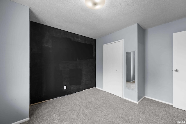 409 W 30th Ave, Milan, IL 61264 - unfurnished bedroom with carpet floors and a textured ceiling