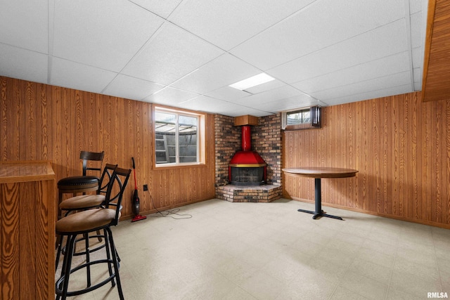 409 W 30th Ave, Milan, IL 61264 - bar area with a wood stove, tile patterned floors, a paneled ceiling, and wood walls