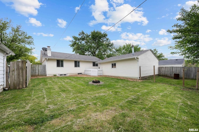 409 W 30th Ave, Milan, IL 61264 - back of house featuring an outdoor fire pit, a fenced backyard, and a chimney