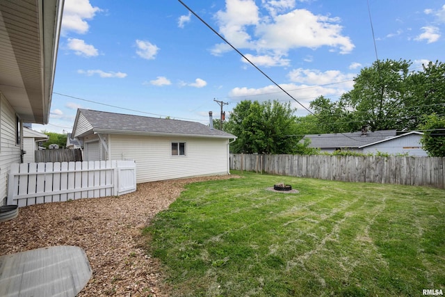 409 W 30th Ave, Milan, IL 61264 - fenced backyard featuring an outdoor fire pit and a garage