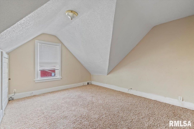 1045-1047 12th St, Rock Island, IL 61201 - bonus room featuring lofted ceiling, a textured ceiling, and carpet flooring