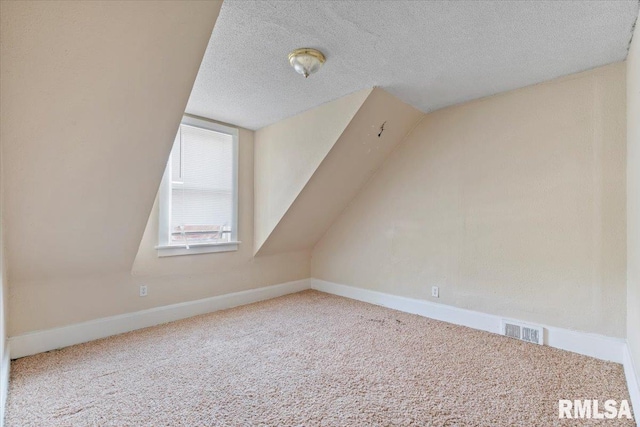 1045-1047 12th St, Rock Island, IL 61201 - bonus room featuring carpet, a textured ceiling, and lofted ceiling