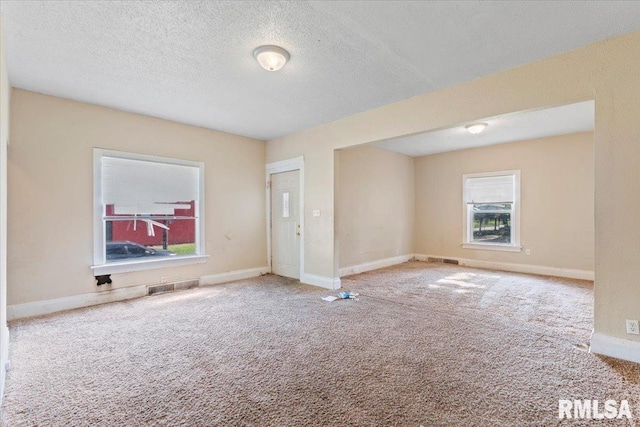 1045-1047 12th St, Rock Island, IL 61201 - empty room with carpet flooring, healthy amount of natural light, and a textured ceiling