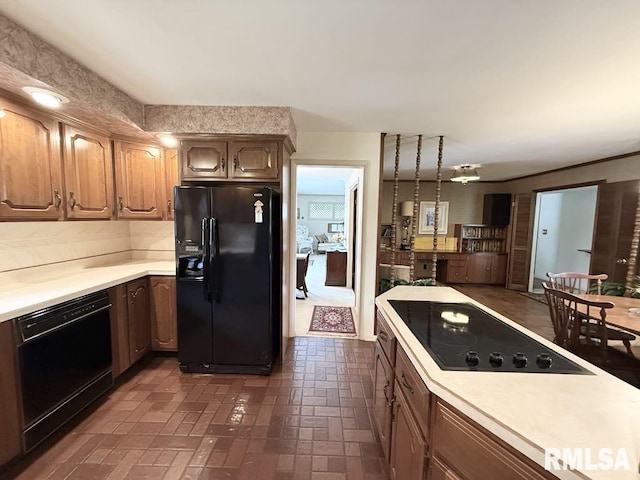 1701 Julianne Dr, Marion, IL 62959 - kitchen featuring black appliances, light countertops, brick patterned floors, and decorative backsplash
