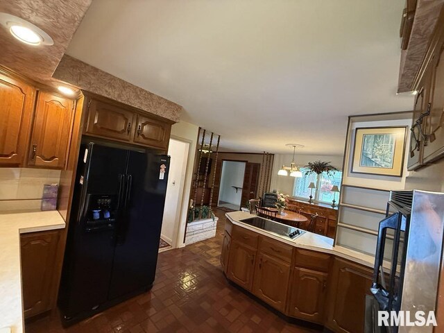 1701 Julianne Dr, Marion, IL 62959 - kitchen with black appliances, light countertops, a peninsula, brick patterned floors, and hanging light fixtures