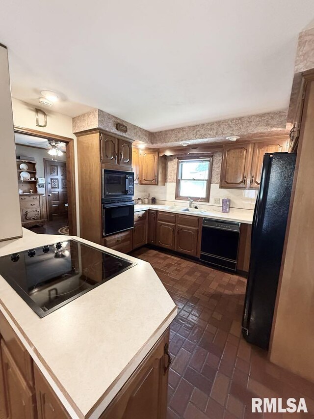 1701 Julianne Dr, Marion, IL 62959 - kitchen with black appliances, light countertops, brick patterned floors, and a ceiling fan