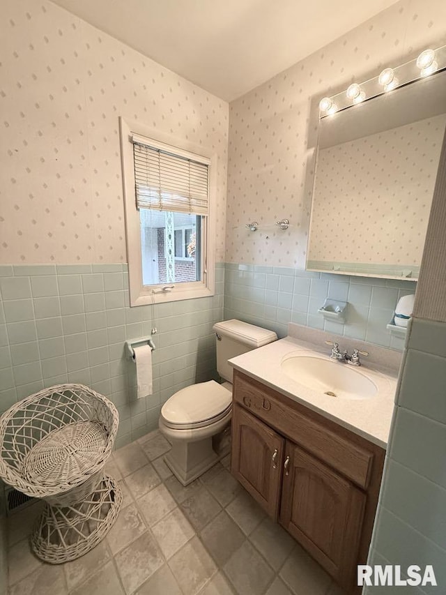 1701 Julianne Dr, Marion, IL 62959 - bathroom with wallpapered walls, wainscoting, vanity, tile walls, and tile patterned floors