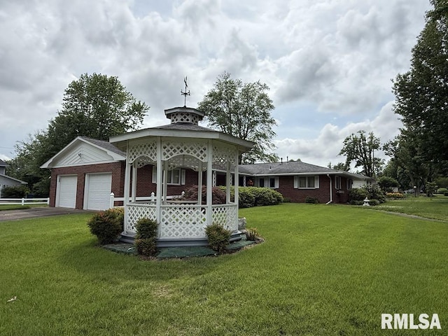 1701 Julianne Dr, Marion, IL 62959 - view of front of house with brick siding, a front lawn, driveway, a gazebo, and an attached garage