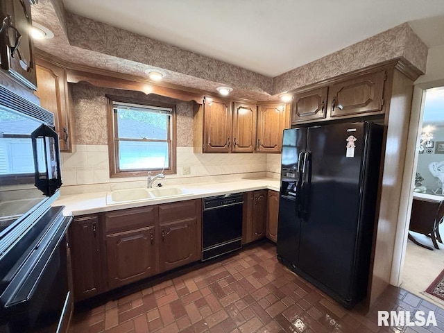1701 Julianne Dr, Marion, IL 62959 - kitchen with black appliances, light countertops, tasteful backsplash, and brick patterned flooring