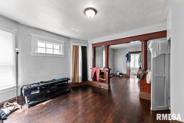 1625 14 1/2 St, Rock Island, IL 61201 - living area featuring wood finished floors, plenty of natural light, and ornate columns