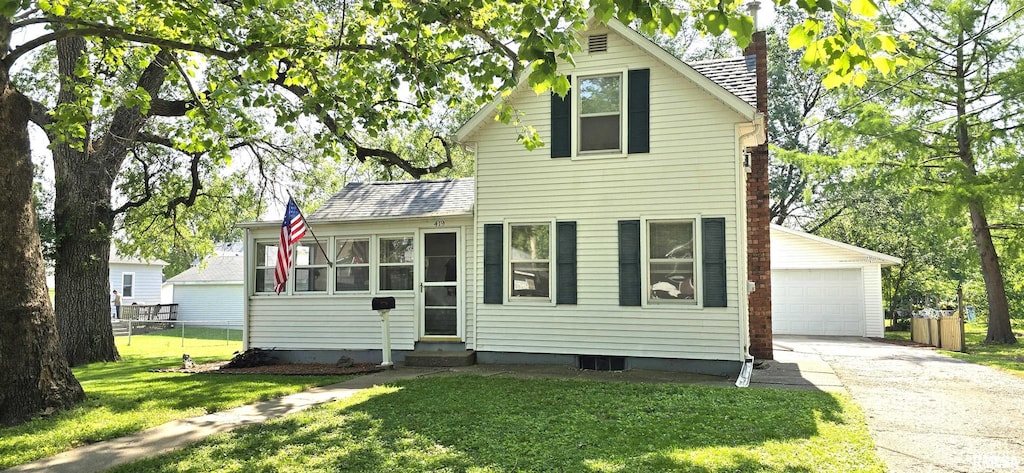 419 S Geneseo St, Geneseo, IL 61254 - traditional-style house featuring entry steps, driveway, a front yard, an outdoor structure, and a detached garage