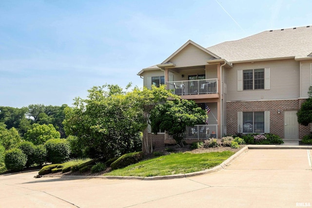 1237 Kimberly Rd, Bettendorf, IA 52722 - view of front of home with brick siding and a balcony