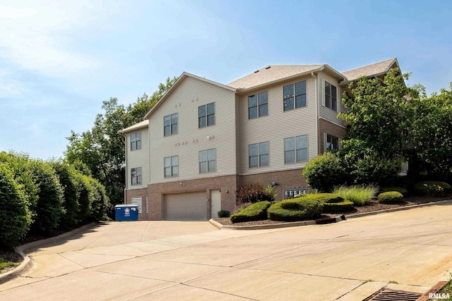 1237 Kimberly Rd, Bettendorf, IA 52722 - view of property featuring a garage and driveway