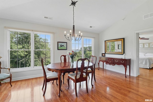 1237 Kimberly Rd, Bettendorf, IA 52722 - dining space featuring wood finished floors, a chandelier, lofted ceiling, and a ceiling fan