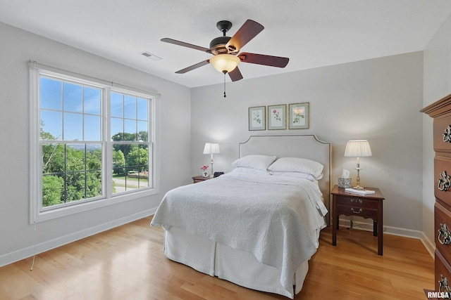 1237 Kimberly Rd, Bettendorf, IA 52722 - bedroom featuring multiple windows, light wood finished floors, and a ceiling fan