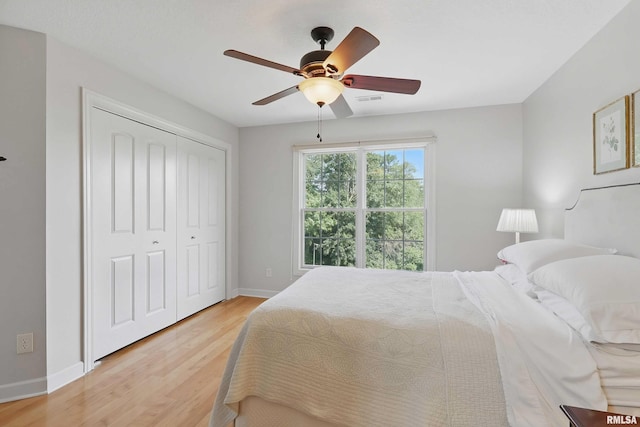 1237 Kimberly Rd, Bettendorf, IA 52722 - bedroom featuring light wood-type flooring, a closet, and ceiling fan