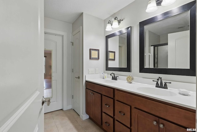 1237 Kimberly Rd, Bettendorf, IA 52722 - full bathroom with double vanity, tile patterned floors, and a shower with shower door