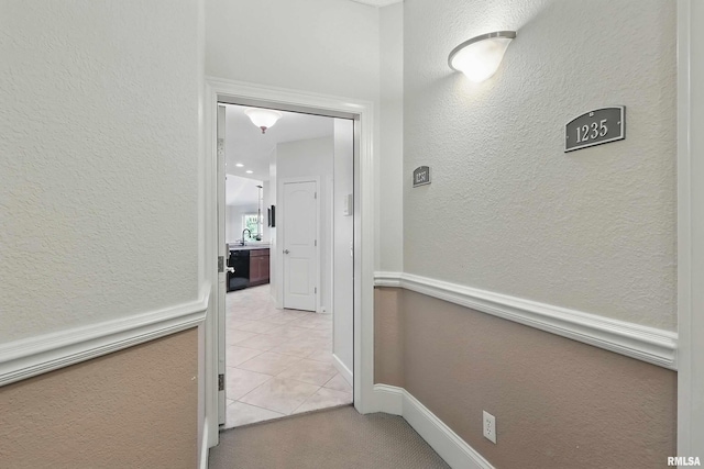 1237 Kimberly Rd, Bettendorf, IA 52722 - corridor with a textured wall and light tile patterned floors