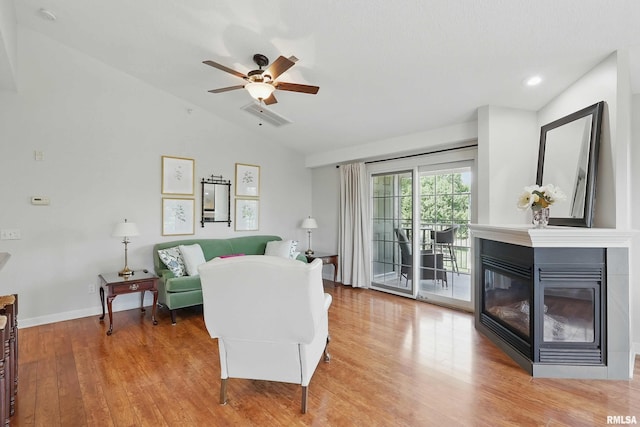 1237 Kimberly Rd, Bettendorf, IA 52722 - living room with lofted ceiling, wood finished floors, a multi sided fireplace, a ceiling fan, and recessed lighting