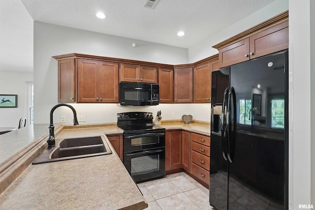 1237 Kimberly Rd, Bettendorf, IA 52722 - kitchen with black appliances, light tile patterned floors, light countertops, a peninsula, and recessed lighting
