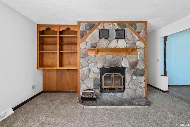3796 160th St, Bryant, IA 52727 - unfurnished living room featuring carpet flooring, a stone fireplace, and a textured ceiling