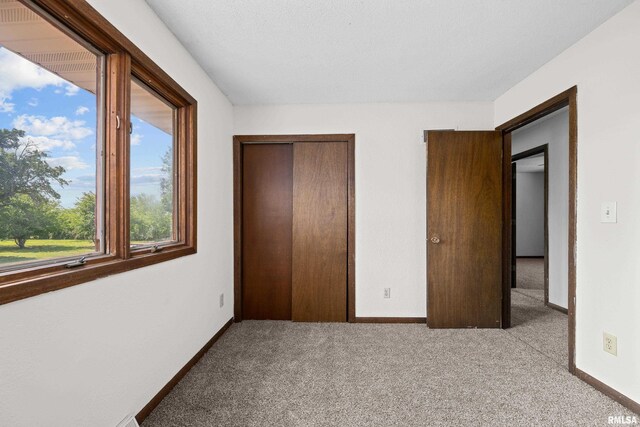 3796 160th St, Bryant, IA 52727 - unfurnished bedroom featuring carpet flooring and a closet